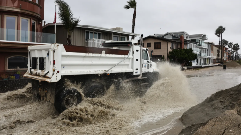 Truck drives through heavy floodwaters