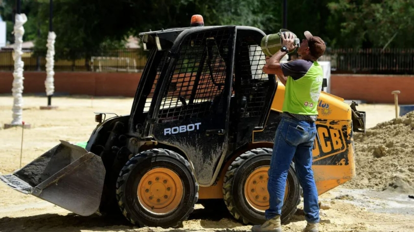 Construction worker drinking water on a hot day