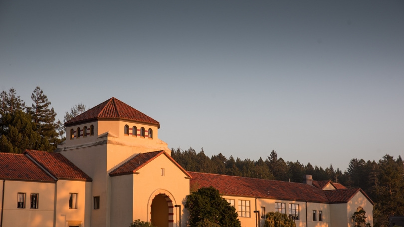 College campus buildings framed by the sunset