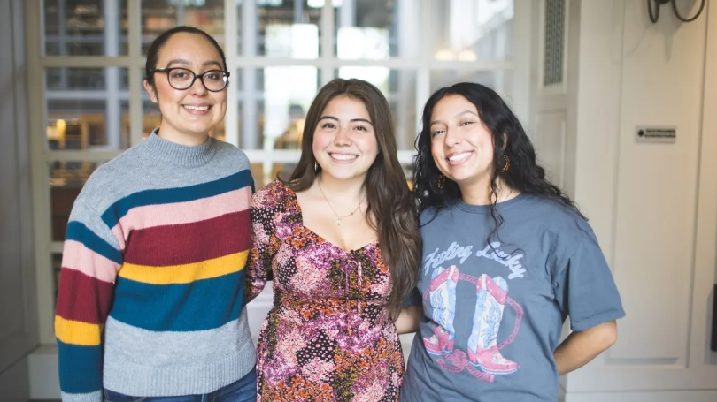 Guadalupe, Jimena, and Lizet smile at camera with arms around each other
