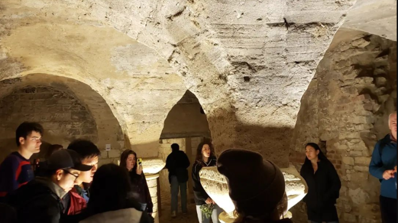 Students stand in dark underground cavern